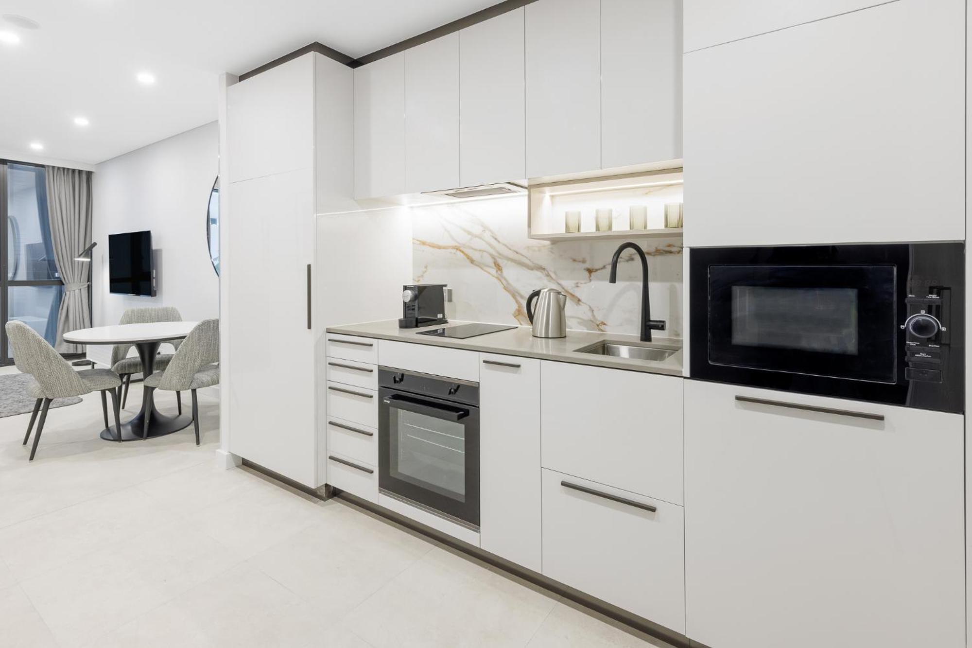 Meriton Suites Canberra Exterior photo A typical kitchen in a serviced apartment